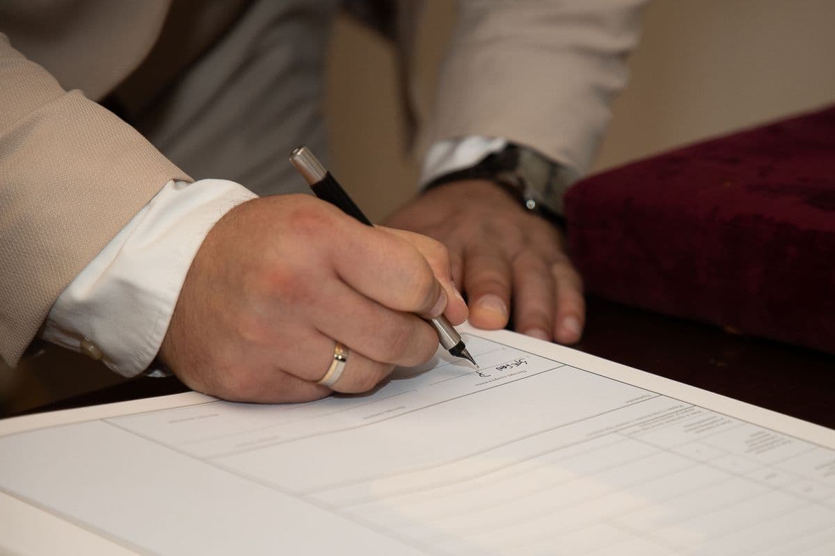 A registration document being signed